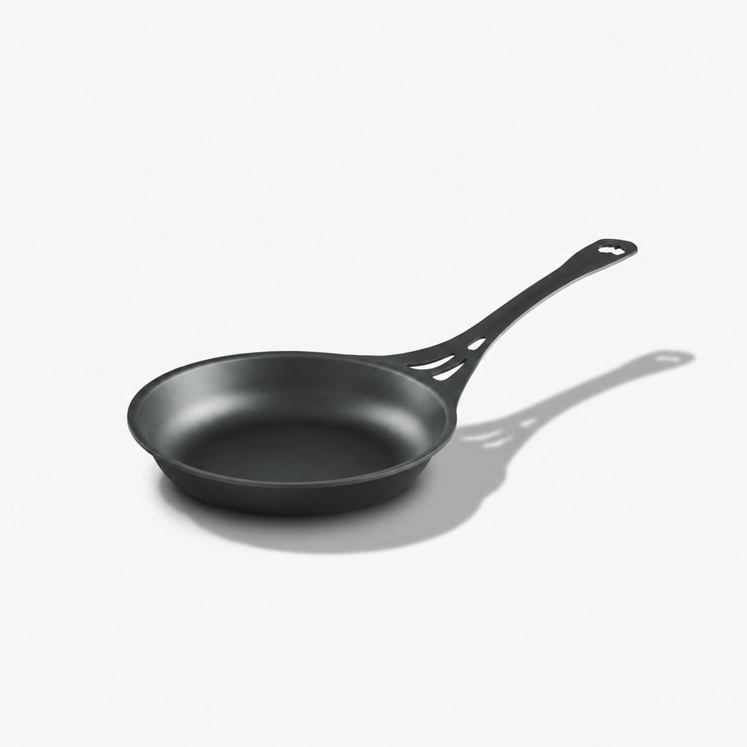 Solidteknics AUS-ION 24cm wrought iron frypan with long vented handle on a light grey background
